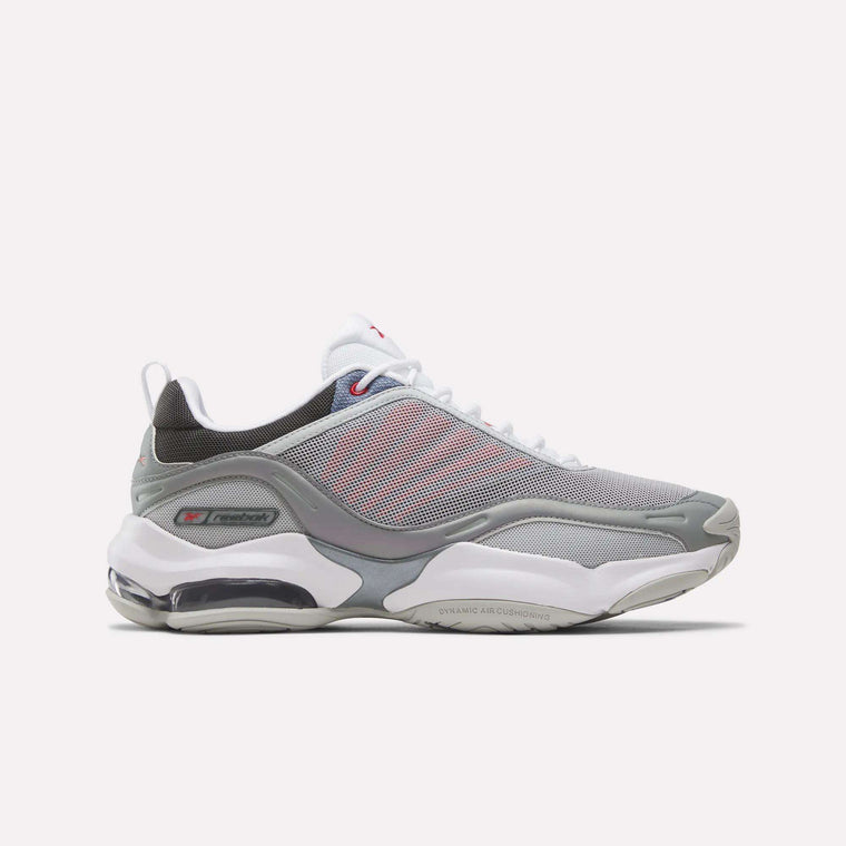 The Reebok DMX Series 3000 Shoes in Grey/White/Red feature mesh panels, white laces, a visible air-cushioned sole with DMX moving air technology for enhanced comfort, and subtle red accents. They are displayed on a plain white background.