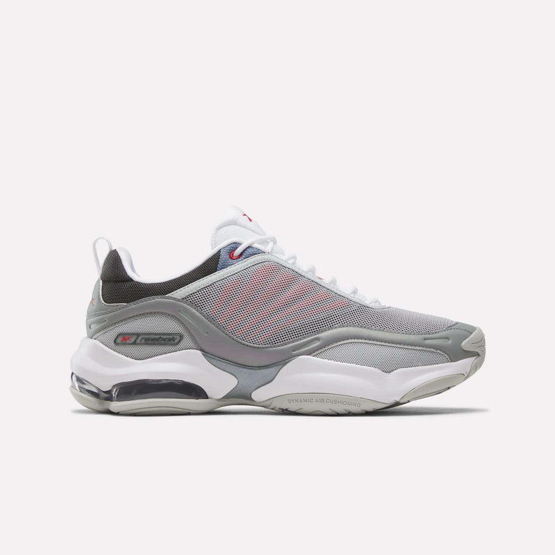 The Reebok DMX Series 3000 Shoes in Grey/White/Red feature mesh panels, white laces, a visible air-cushioned sole with DMX moving air technology for enhanced comfort, and subtle red accents. They are displayed on a plain white background.