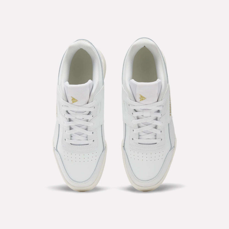 A pair of Reebok Workout Plus Shoes for big kids with laces, seen from above on a light background. These sporty white sneakers have perforated toe boxes and gold triangle logos on the tongues—ideal for juniors who want style and comfort.