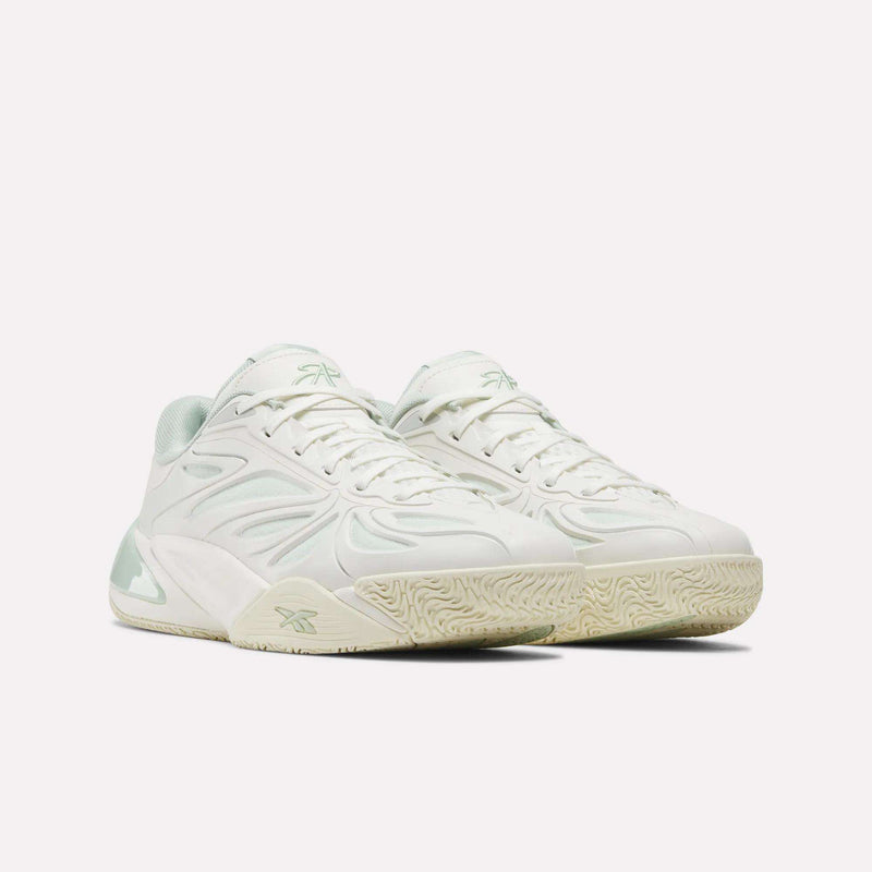 A pair of white Reebok Angel Reese 1 Basketball Shoes with light green accents, featuring a textured sole and wavy design patterns on the sides, incorporates the innovative Reebok Energy Return System for enhanced comfort and responsiveness—making them as stylish as they are functional. Displayed on a plain white background.
