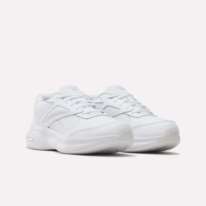 A pair of white Men’s DMX Comfort+ Walk Ultra Shoes by Reebok, featuring thick soles and lace-up fronts, are displayed side by side against a plain light background; these athletic sneakers offer advanced DMX Comfort+ cushioning for exceptional support during walking.