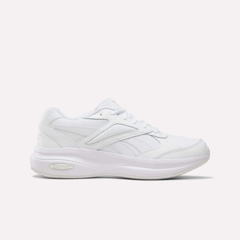 Aha - White/White/White men’s DMX Comfort+ Walk Ultra Shoes from Reebok are pictured in a side profile against a plain light background. These athletic sneakers feature a thick sole, lace-up closure, and subtle stitched detailing, and are designed as men’s walking shoes with advanced DMX Comfort+ cushioning for all-day comfort and support.