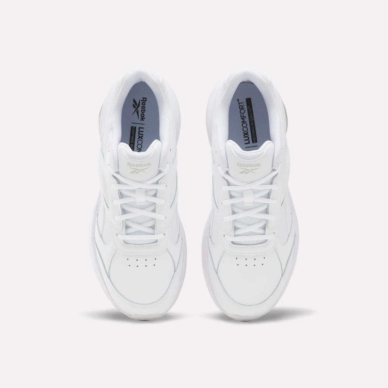 A pair of Reebok Men’s DMX Comfort+ Walk Ultra Shoes in white are viewed from above, showcasing visible laces and perforations on the toe area, positioned side by side against a plain light background. These walking shoes incorporate DMX Comfort+ cushioning, delivering enhanced support with every stride.