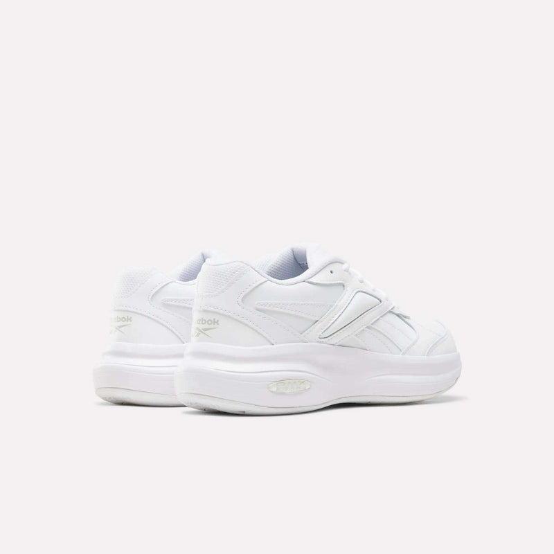 A pair of Reebok Women’s DMX Comfort + Walk Ultra Shoes in white, featuring thick soles and advanced DMX Comfort+ cushioning for superior support, shown from the back and side against a plain light background—ideal women’s walking shoes for all-day comfort.