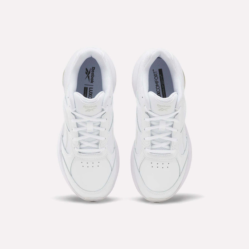 A pair of Women’s DMX Comfort + Walk Ultra Shoes by Reebok in white, viewed from above to showcase the laces, perforated toe detailing, and Reebok branding on the tongue and insole—all set against a plain light background. These walking shoes are enhanced with DMX Comfort+ cushioning for all-day comfort.