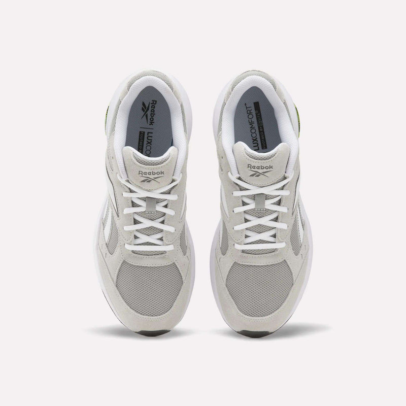 A pair of Reebok Men’s DMX Comfort+ Walk Ultra shoes in white, seen from above, showcase mesh and suede panels, white laces, the Reebok logo on the tongues, and advanced DMX Comfort+ technology—making them a top choice for men’s walking footwear.