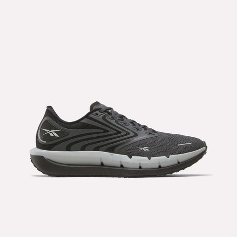 The Reebok Men's FloatZig Tread Running Shoes in black and gray feature a mesh upper, lace-up closure, thick cushioned midsole for comfort during treadmill workouts, and display the Reebok logo on the heel and side.