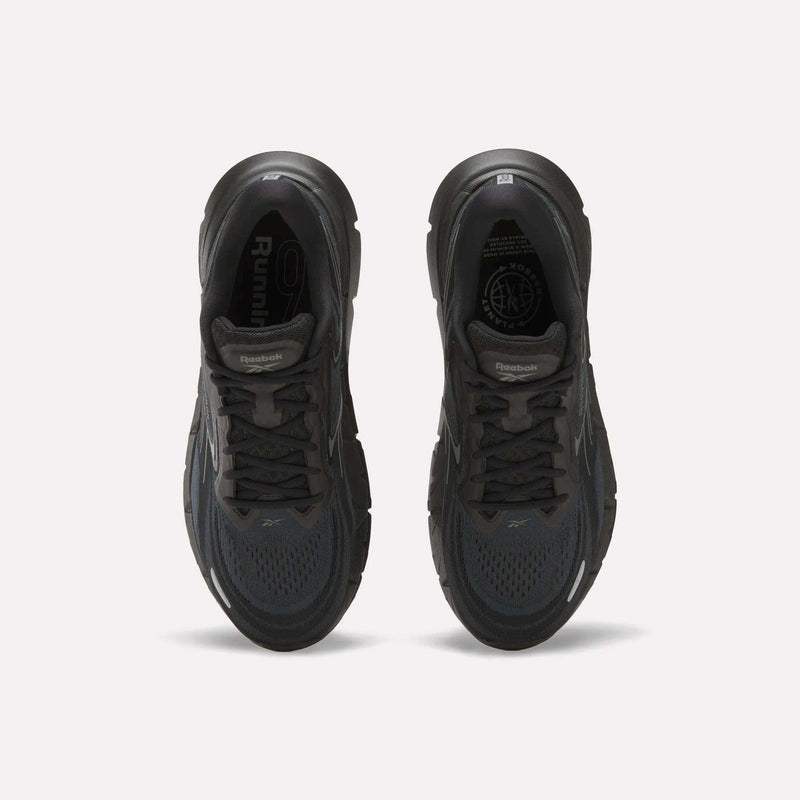 Top view of a pair of Reebok Men's FloatZig Double Running Shoes in black, featuring cushioned soles, dark laces, and mesh uppers, displayed side by side on a plain white background.