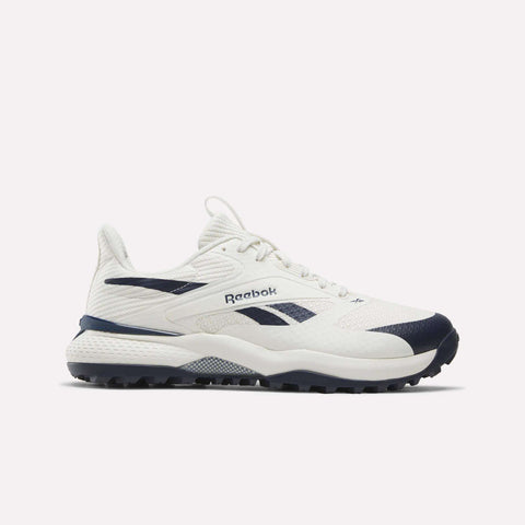 Navy and chalk Reebok Nano Golf Shoes featuring a mesh upper and Floatride foam for enhanced comfort, lace-up closure, branded side logo, and a textured rubber sole, displayed on a plain white background.