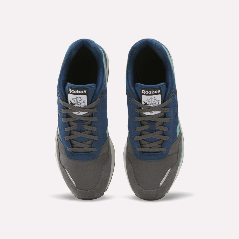 Top view of a pair of Reebok Men’s GL1600 Shoes featuring blue and gray panels, white midsoles, and gray laces, placed side by side on a white background.