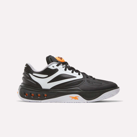 The Reebok Engine A Pump Shoes are black and white athletic sneakers with orange accents, featuring a white sole and multiple ventilation holes along the midsole. Designed for ultimate comfort and agility on the court, these performance basketball shoes incorporate advanced Pump technology for a customizable fit during dynamic play. Shown here on a plain white background.
