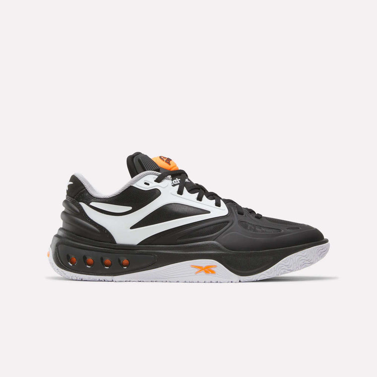 The Reebok Engine A Pump Shoes are black and white athletic sneakers with orange accents, featuring a white sole and multiple ventilation holes along the midsole. Designed for ultimate comfort and agility on the court, these performance basketball shoes incorporate advanced Pump technology for a customizable fit during dynamic play. Shown here on a plain white background.