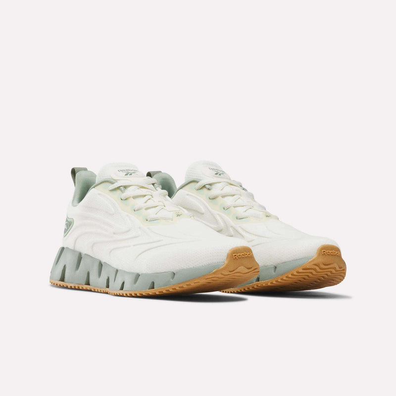 Women’s Zig Futaura 1.0 Shoes in white with light green accents, featuring a zigzag-shaped FuelFoam midsole over a gum rubber outsole.
