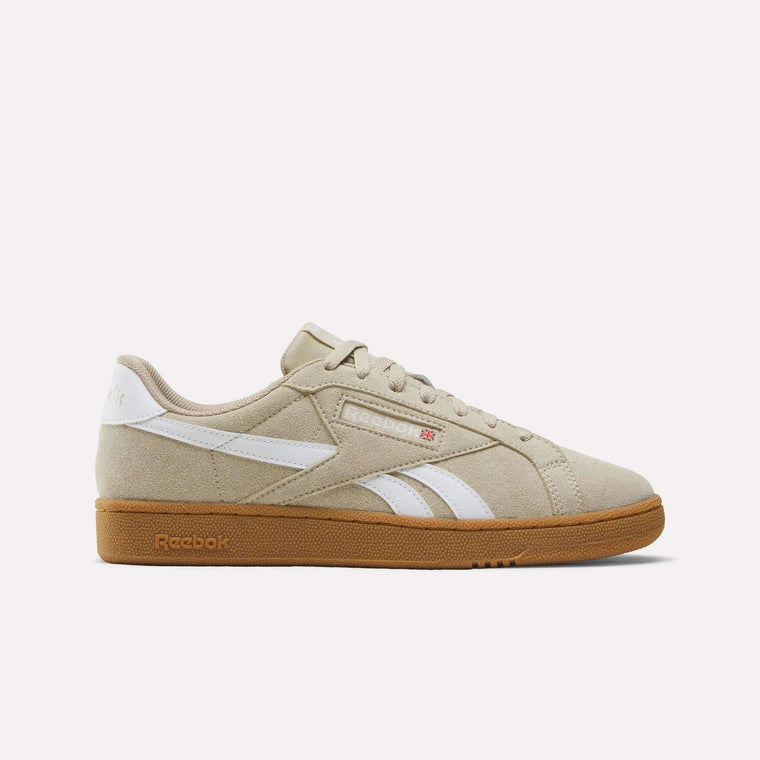 The Men’s Club C Grounds UK 1.0 Shoes by Reebok in Elevated Beige/White feature signature white stripes and branding, beige laces, and a brown rubber sole. Displayed on a clean white background, these men’s sneakers embody classic Reebok heritage for a timeless vintage look.