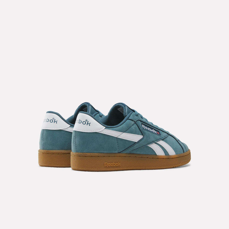 A pair of Men’s Club C Grounds UK 1.0 Shoes by Reebok in teal suede with white stripes and gum soles, inspired by Reebok heritage, shown from the back and side against a plain white background.