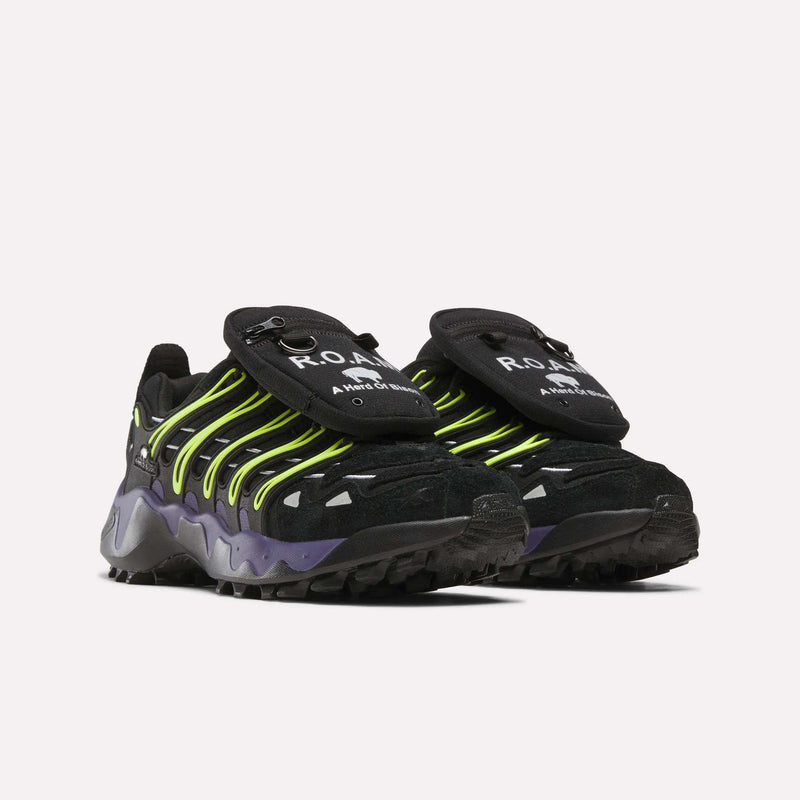 Reebok x A Herd of Bison Men’s Trailzillo DMX Shoes in black with neon yellow laces, purple midsoles, and detachable zippered tongue pouches featuring a white bison logo, built with DMX Dynamic Air Cushioning and Vibram rubber for rugged performance.