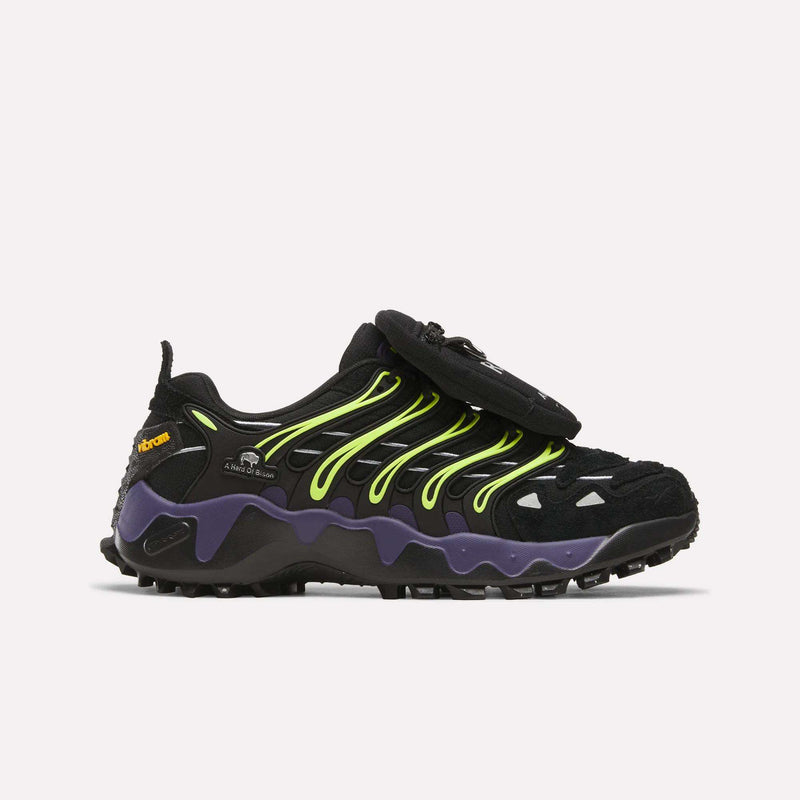Reebok x A Herd of Bison Men’s Trailzillo DMX shoes in black with neon lime accents, a purple molded midsole, a rugged Vibram rubber outsole, and a small removable pouch attached to the laces.