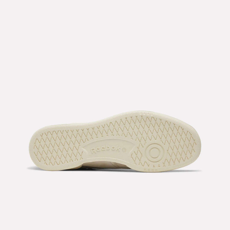Beige outsole of the Men’s Club C 85 Shoes by Reebok shown laying flat, featuring a textured tread pattern with zigzag grooves and Reebok branding centered—ideal for retro sneaker enthusiasts and fans of classic Reebok style.