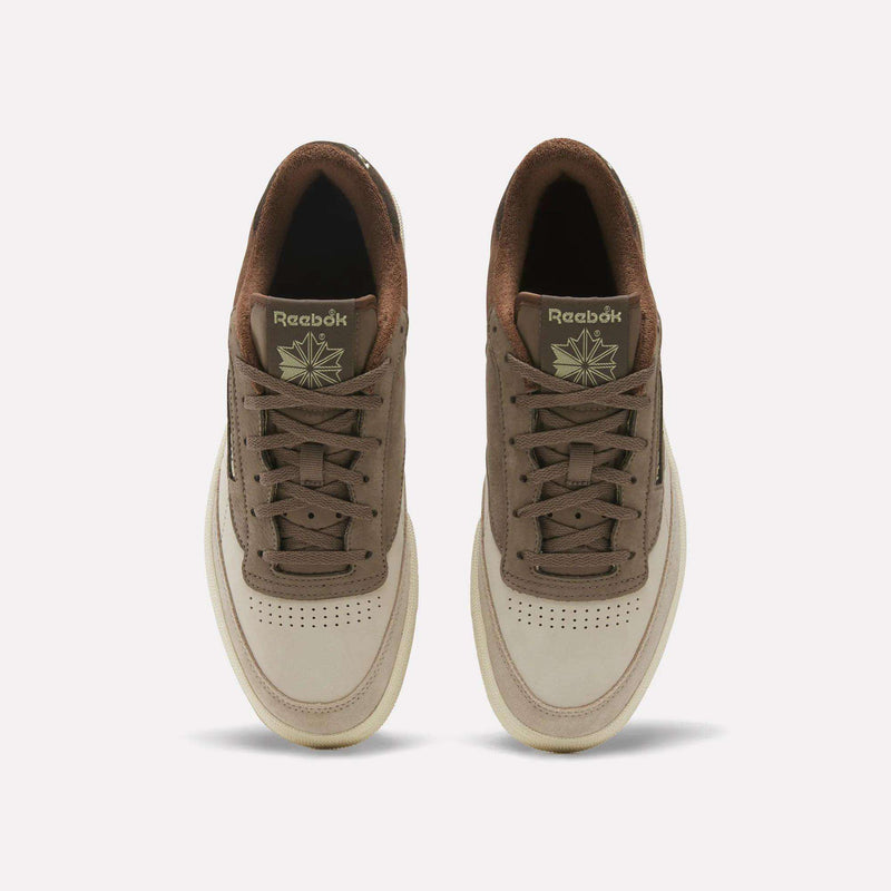 Top view of a pair of Reebok Men’s Club C 85 Shoes with beige toes, brown accents, brown laces, and a brown inner lining, displayed side by side on a white background.