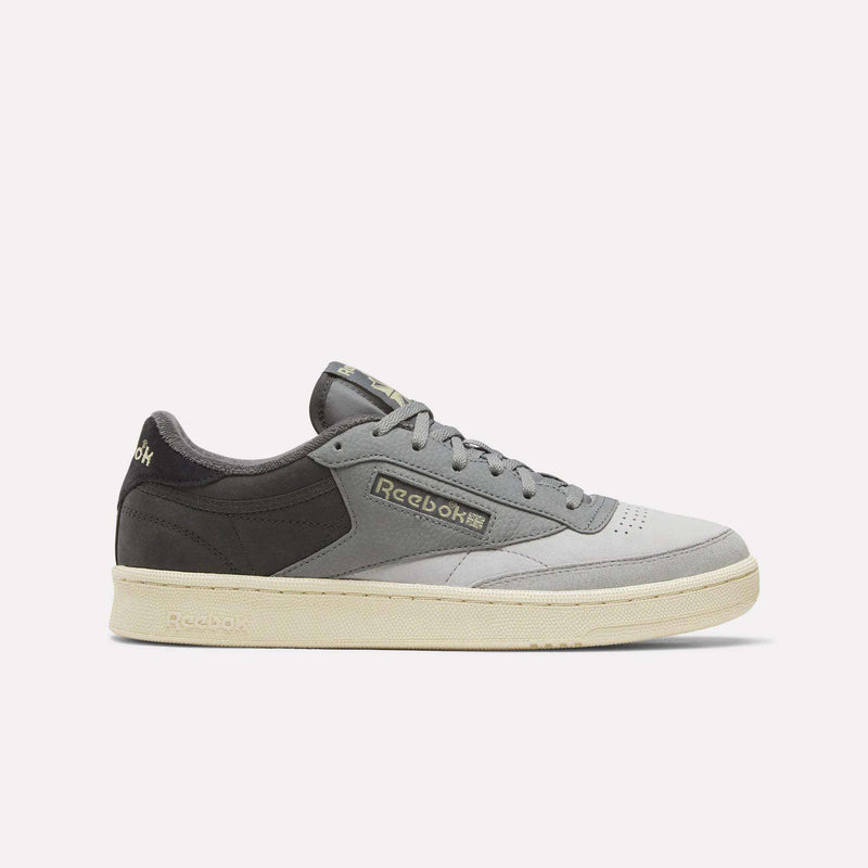 Reebok Men’s Club C 85 Shoes in shades of grey, featuring a perforated toe box and an off-white rubber sole.