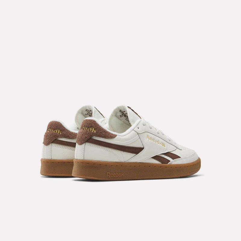 Men's Club C Revenge Vintage Shoes by Reebok—white leather sneakers with brown suede accents, gold Reebok branding, and gum rubber soles. Shown side and back on white, these sneakers offer classic vintage style.