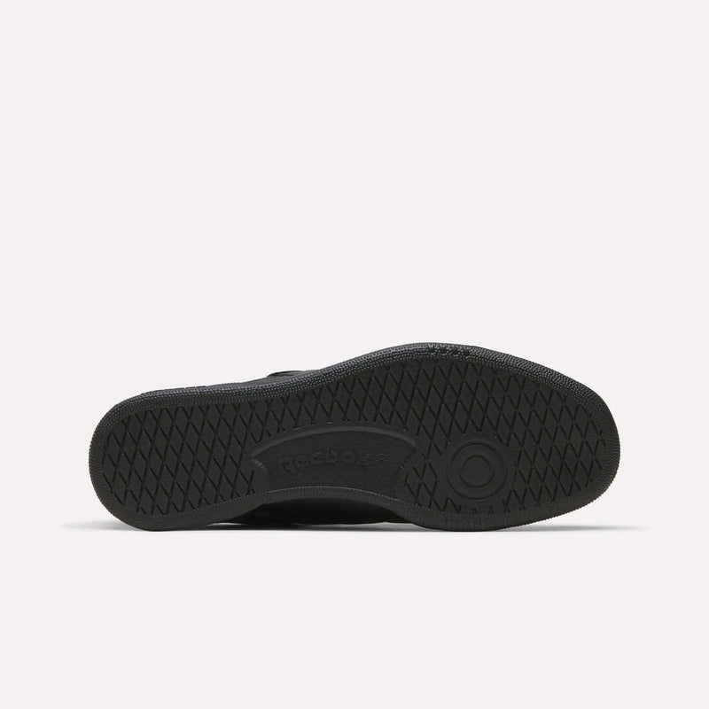 Black Reebok Men’s Club C 85 Shoe shown from the bottom, highlighting its textured rubber sole with a circular pattern and the Reebok logo at the center. Made from premium garment leather, this retro sneaker stands out against a plain white background.