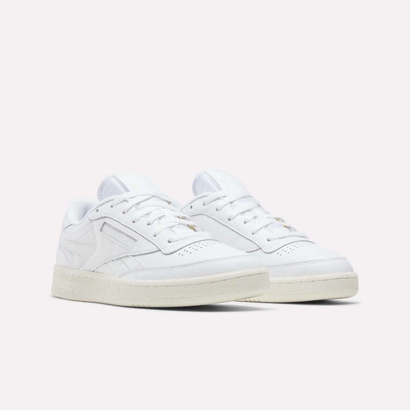 A pair of Reebok Men’s Club C Revenge Shoes in white with off-white soles, showcased at an angle on a plain light background.