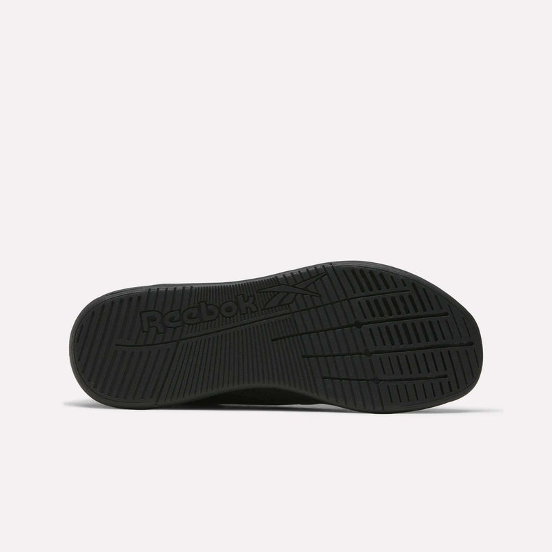 The image displays the black rubber sole of Reebok Nano X5 Training Shoes from the bottom, featuring textured grip patterns and an embossed logo, emphasizing comfort and support. The background is plain white.
