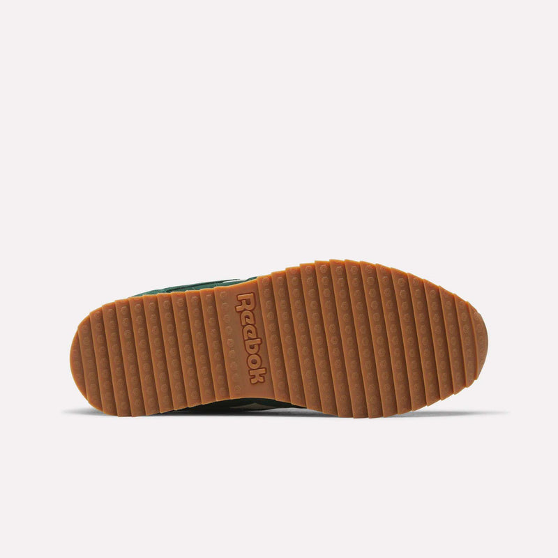 The Men’s Classic Leather Ripple Shoes by Reebok feature a brown ridged rubber sole with the Reebok logo embossed at the center, seen from the bottom against a white background. This design also includes an EVA midsole for enhanced comfort and support, showcasing Reebok’s iconic style and innovation.