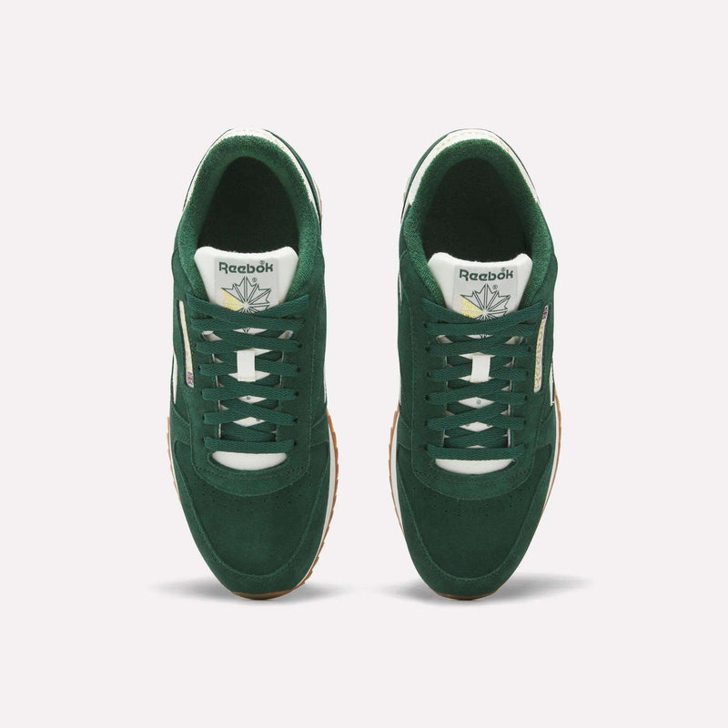 Top view of a pair of Reebok Men’s Classic Leather Ripple Shoes in green, featuring white laces and a logo on the tongue, with an EVA midsole for added comfort, displayed side by side on a light background.