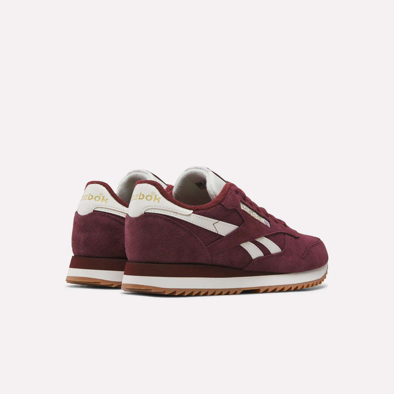 A pair of Men’s Classic Leather Ripple Shoes by Reebok in maroon with white accents and gum soles, highlighted by an EVA midsole for superior cushioning, positioned at an angle to showcase the side and back of both shoes against a plain white background.