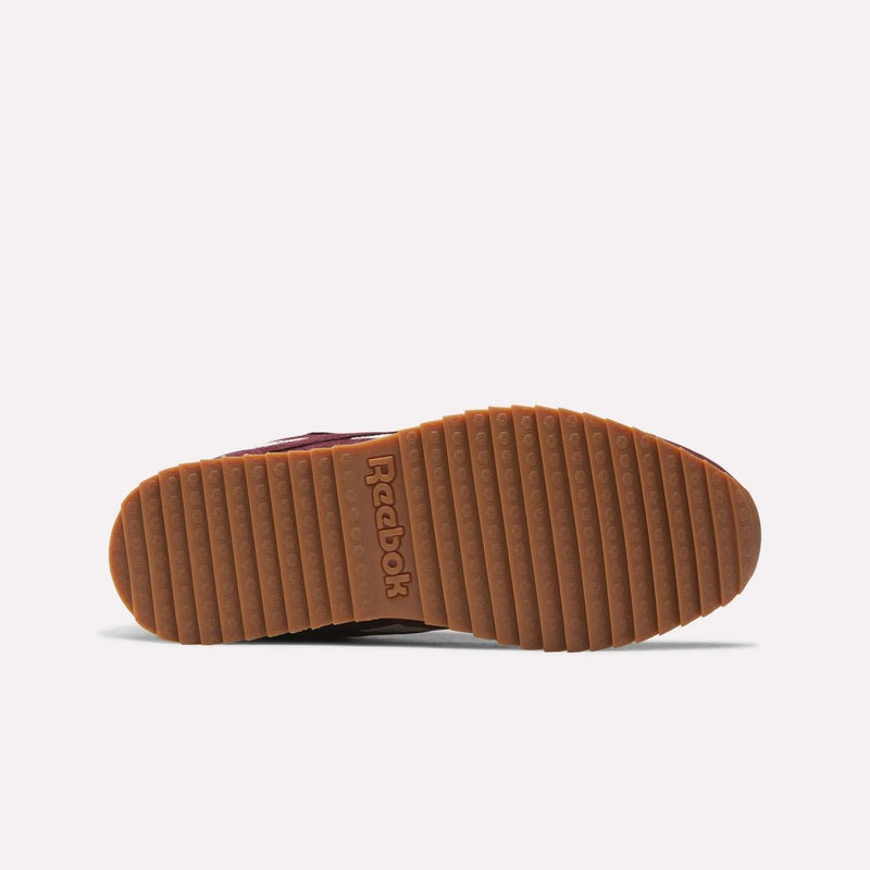 Bottom view of the Men’s Classic Leather Ripple Shoes by Reebok, showcasing a light brown rubber sole with horizontal grooves and the Reebok logo embossed at the center. The sneaker is set against a plain white background.