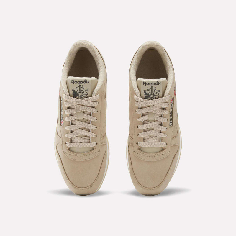 A pair of Men’s Classic Leather Ripple Shoes by Reebok in beige is seen from above, highlighting the laces, branded tongues, and subtle stitching details against a plain white background.