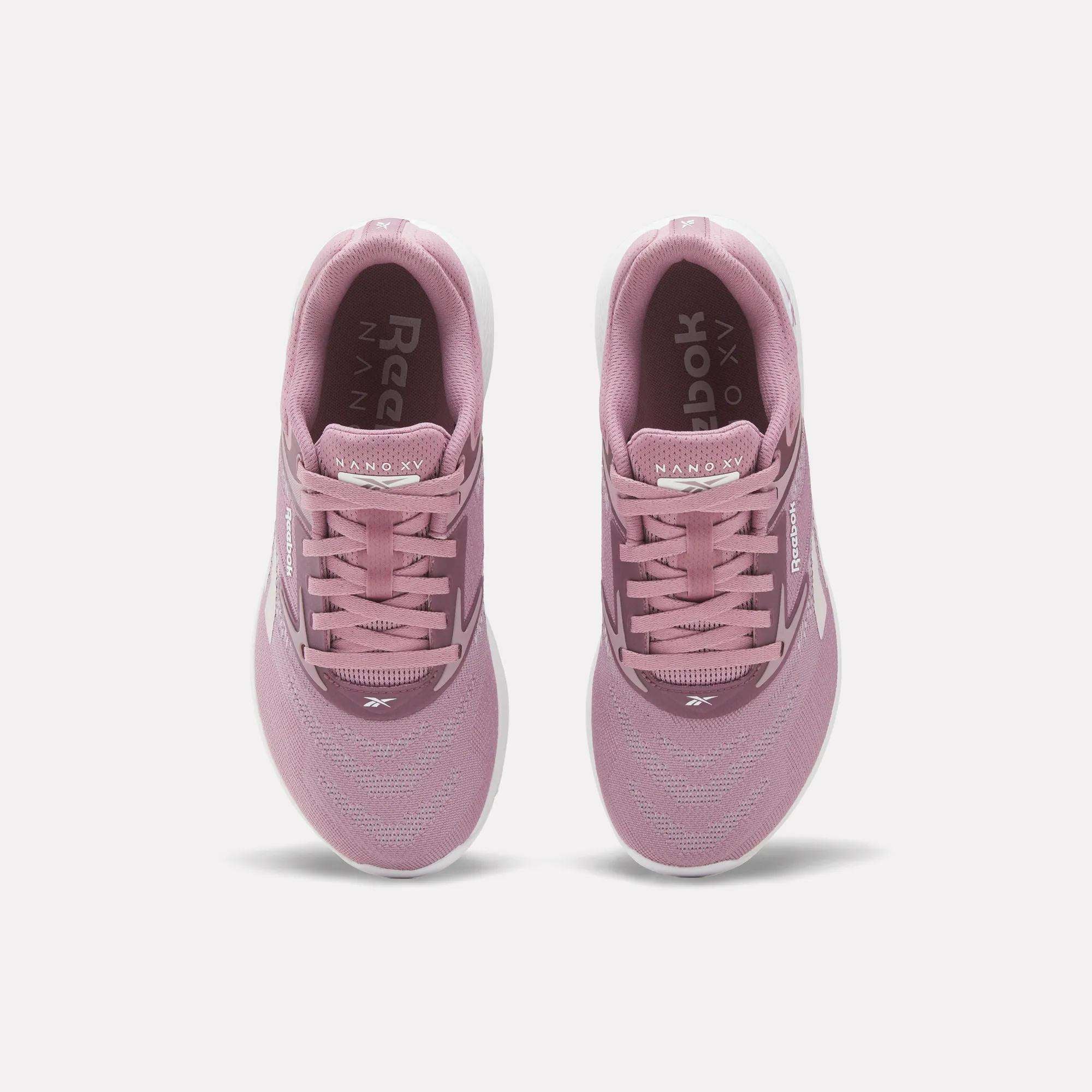 A pair of Reebok Nano X5 Women's Training Shoes in pink, viewed from above with visible laces, mesh upper, dual-density midsole, and white soles on a plain white background—ideal for stylish support during training.