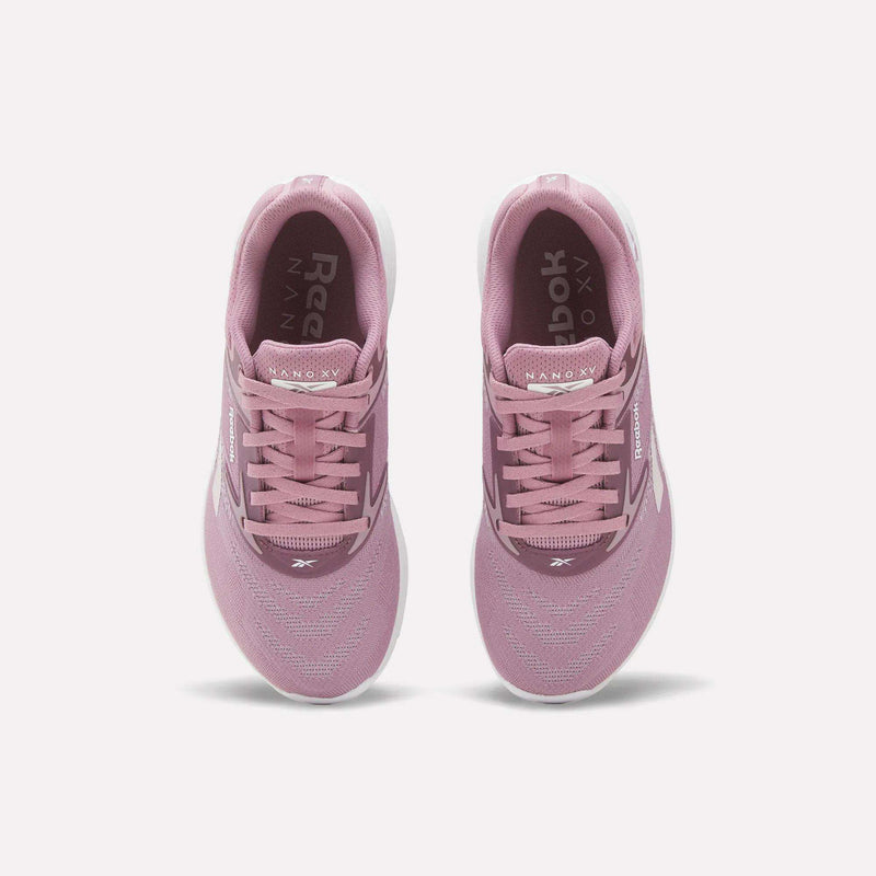A pair of Reebok Nano X5 Women's Training Shoes in pink, viewed from above with visible laces, mesh upper, dual-density midsole, and white soles on a plain white background—ideal for stylish support during training.