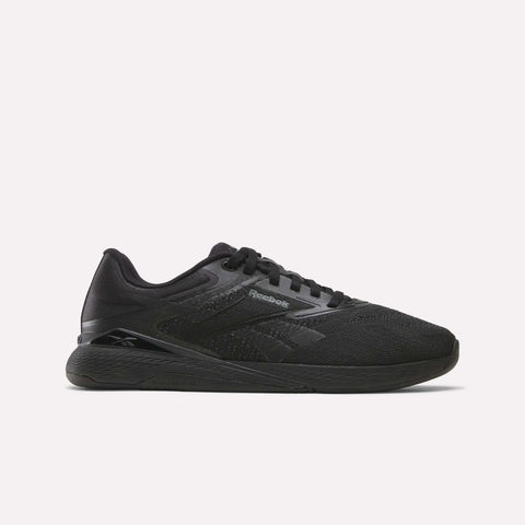 An espresso-colored athletic sneaker with a mesh upper, matching sole, and subtle Reebok branding on the side, the Women’s Nano X5 Training Shoes by Reebok are displayed on a plain white background—ideal training shoes designed for all-day comfort.