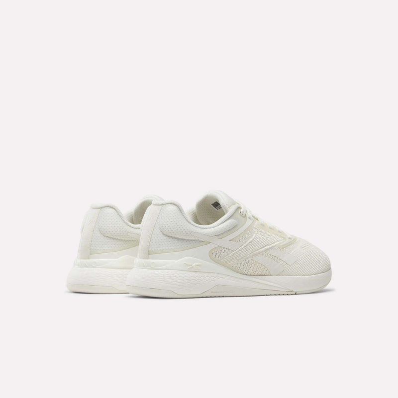 A pair of Reebok Nano X5 Women's Training Shoes in off-white, featuring textured uppers and thick soles, displayed at an angle against a plain white background.