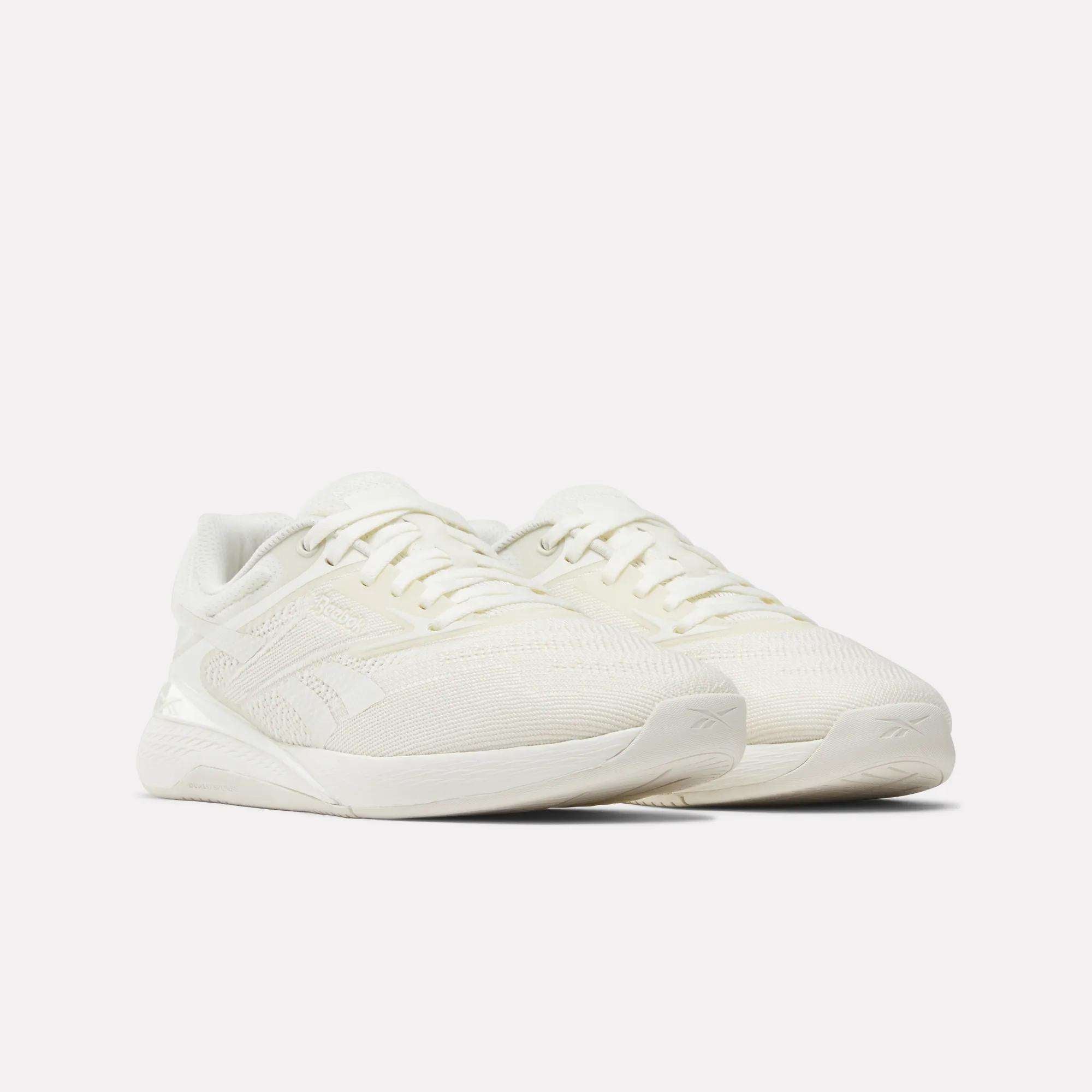 A pair of Reebok Nano X5 Women's Training Shoes in white, featuring a textured mesh upper, lace-up design, and cushioned soles, shown on a plain white background.