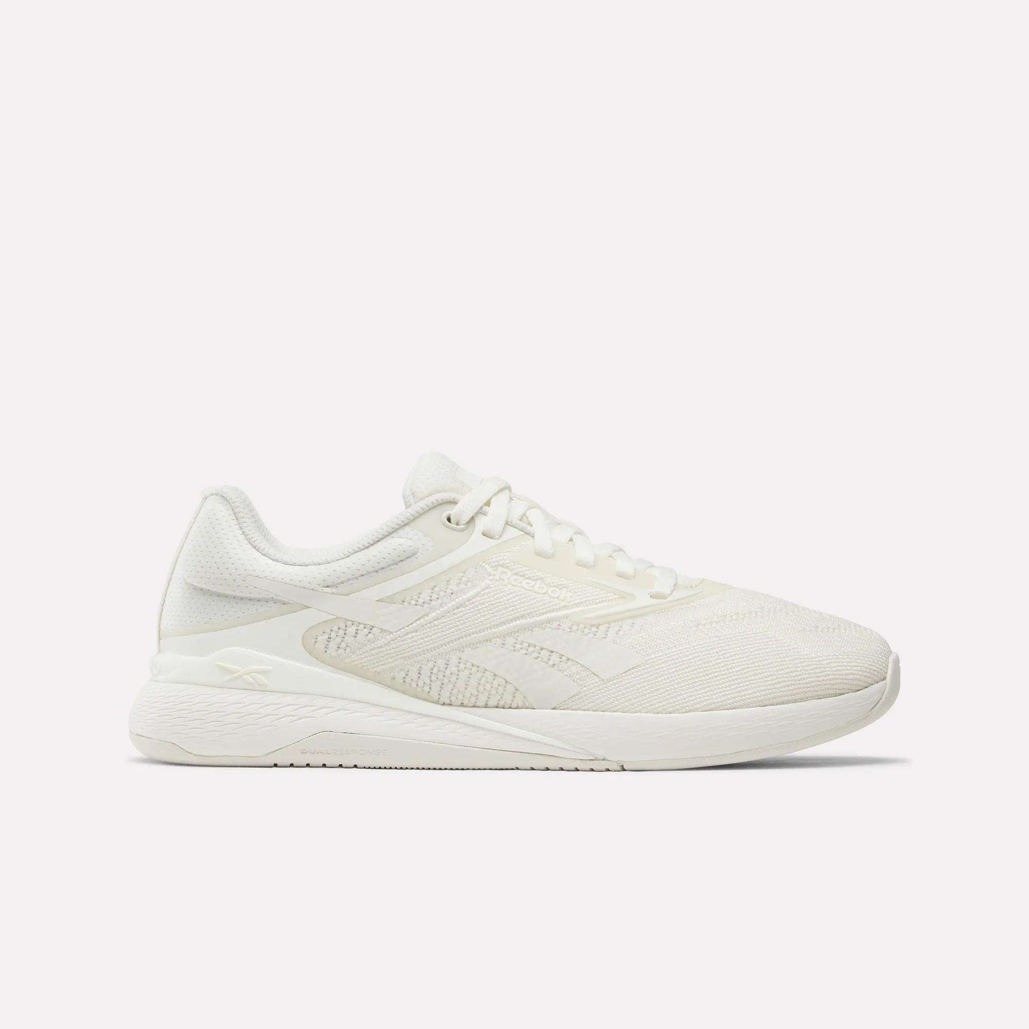 A side view of Reebok Nano X5 Women's Training Shoes in white, featuring a textured mesh design, lace-up closure, and slightly elevated sole, displayed against a plain white background.