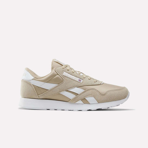 Elevated Beige and white Men’s Classic Nylon Shoes by Reebok, featuring a white sole, classic white side stripes, and a small Union Jack logo near the laces—timeless men’s sneakers inspired by retro styles, shown on a plain white background.