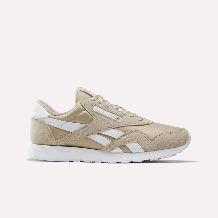Elevated Beige and white Men’s Classic Nylon Shoes by Reebok, featuring a white sole, classic white side stripes, and a small Union Jack logo near the laces—timeless men’s sneakers inspired by retro styles, shown on a plain white background.