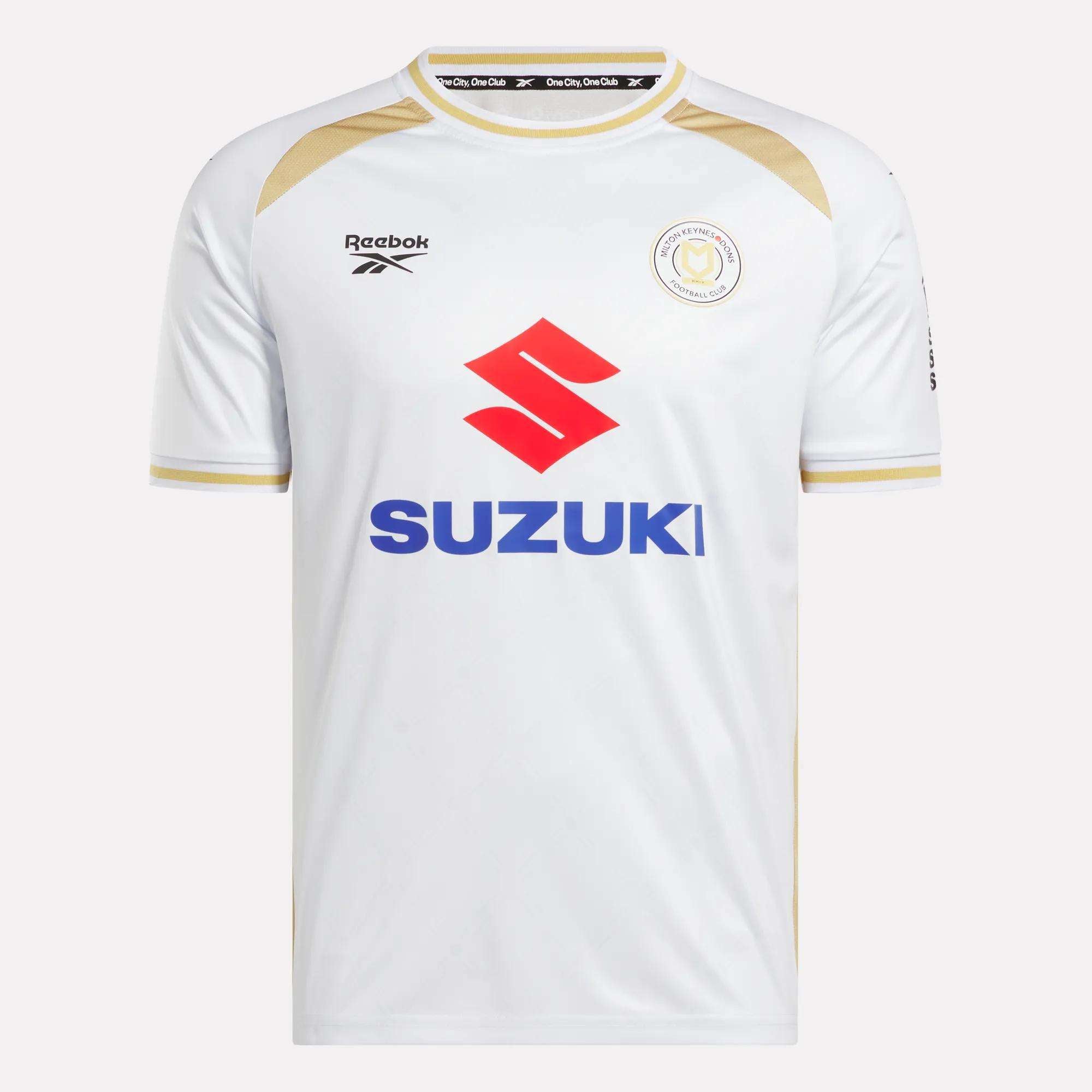 The Men's MK Dons Home Jersey by Reebok is a white football shirt with gold trim, a bold red Suzuki logo on the front, and a circular team crest on the left chest—an iconic piece for Milton Keynes fans.