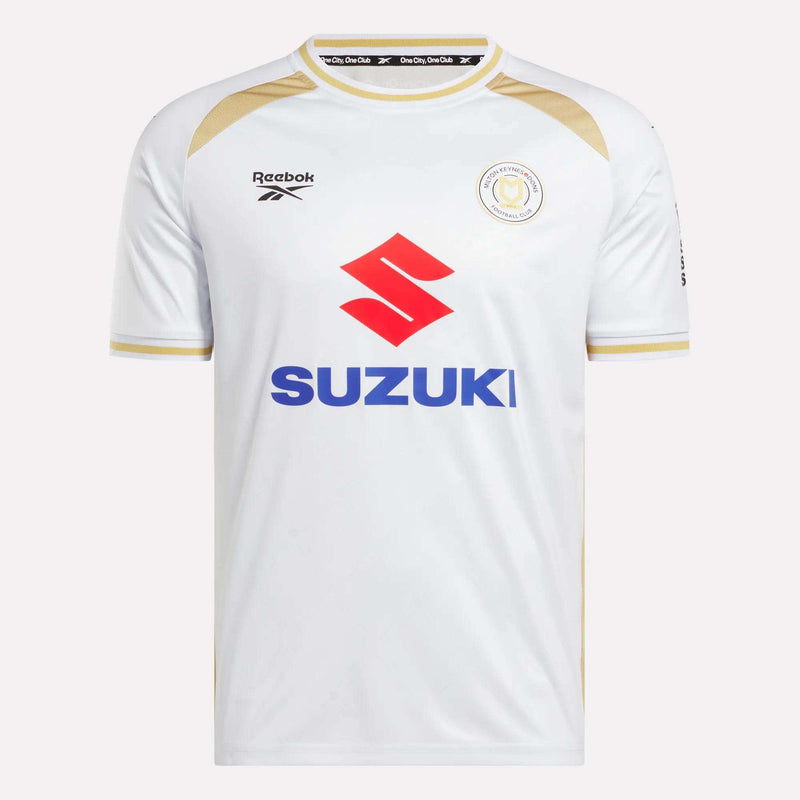 The Men's MK Dons Home Jersey by Reebok is a white football shirt with gold trim, a bold red Suzuki logo on the front, and a circular team crest on the left chest—an iconic piece for Milton Keynes fans.