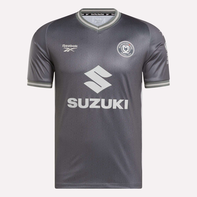 The Men's MK Dons Away Jersey by Reebok features a subtle gray pattern, a circular team crest on the chest, and SUZUKI across the front—a stylish soccer jersey inspired by Bletchley Park heritage.