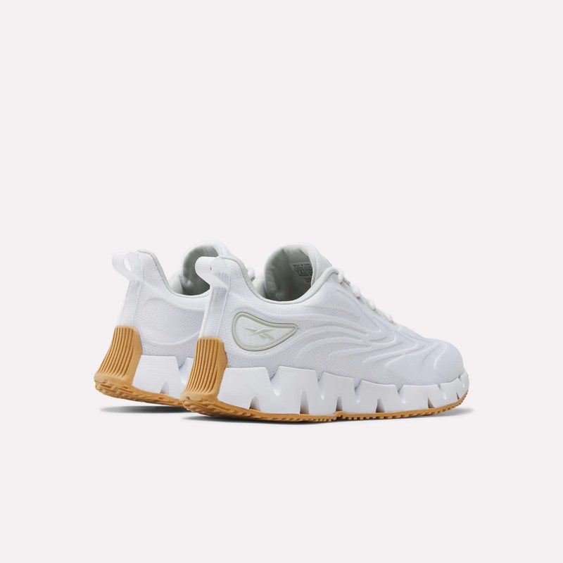 Women’s Zig Futaura 1.0 Shoes in white with a thick, jagged FuelFoam midsole and a tan rubber heel detail.