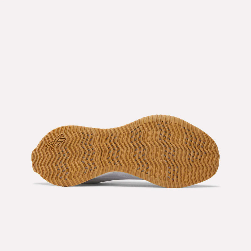 The underside of a Women’s Zig Futaura 1.0 shoe, featuring a wavy, tan rubber tread pattern.