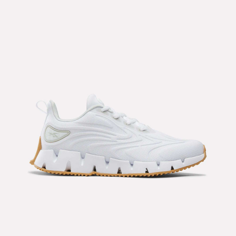 Women’s Zig Futaura 1.0 Shoes in white featuring a mesh upper, a distinctive zig-zag shaped FuelFoam midsole, and a gum-colored rubber outsole.