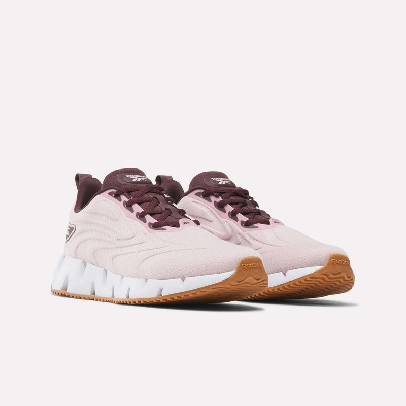 Women’s Zig Futaura 1.0 Shoes in light pink with dark red accents, featuring a thick, jagged white FuelFoam midsole and a gum rubber outsole.