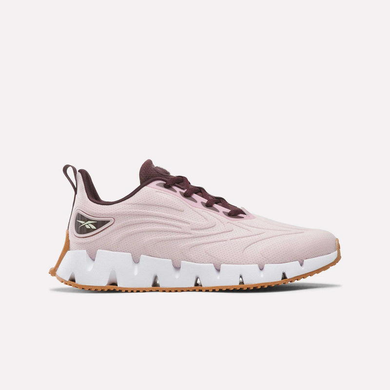 Women’s Zig Futaura 1.0 Shoes in pale pink mesh with a thick, zigzag-patterned white FuelFoam midsole and a brown rubber outsole.