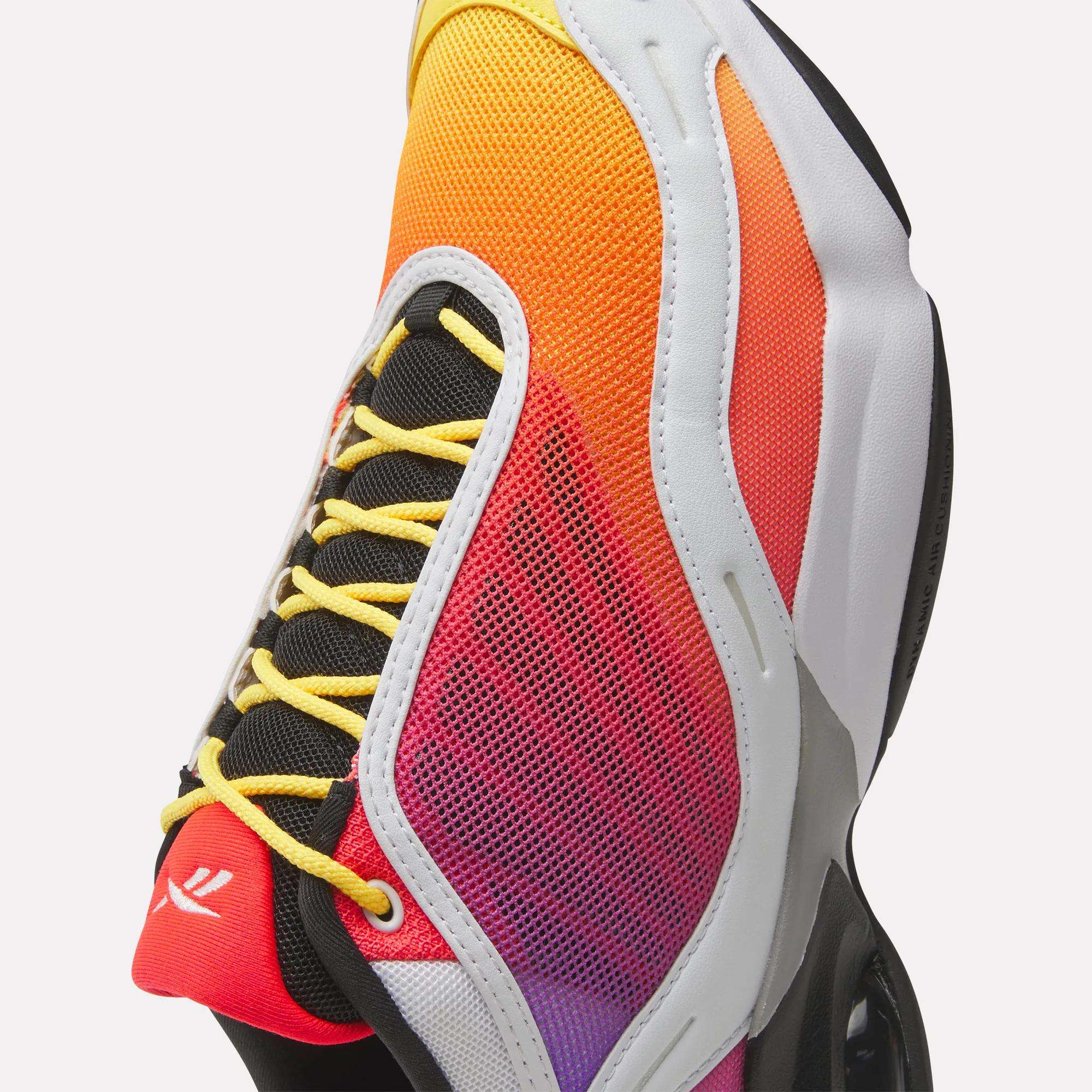 Multicolored sneaker with yellow laces on a white background